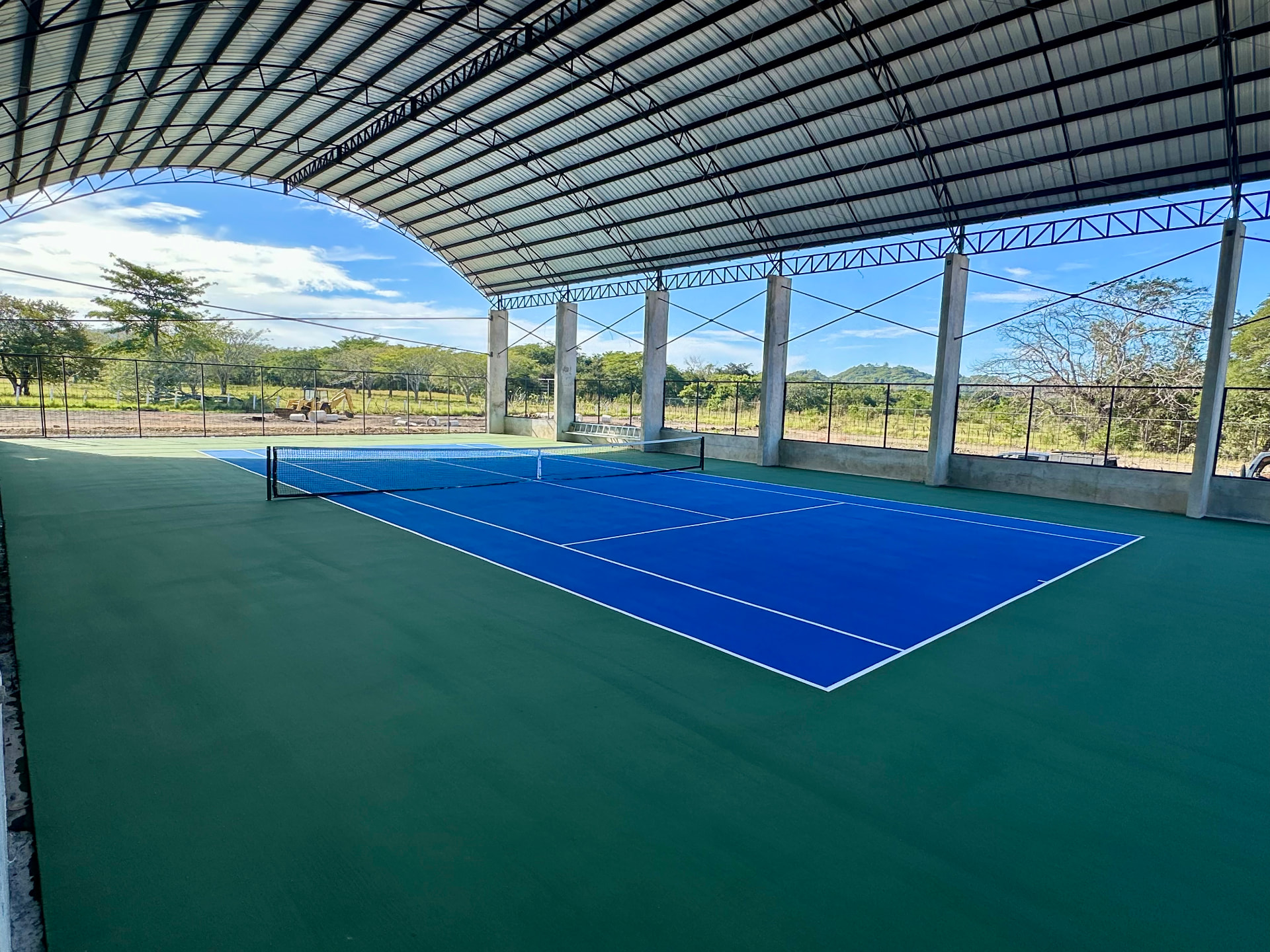 Fully covered tennis court at Finca Escondida with open views to the Guanacaste countryside