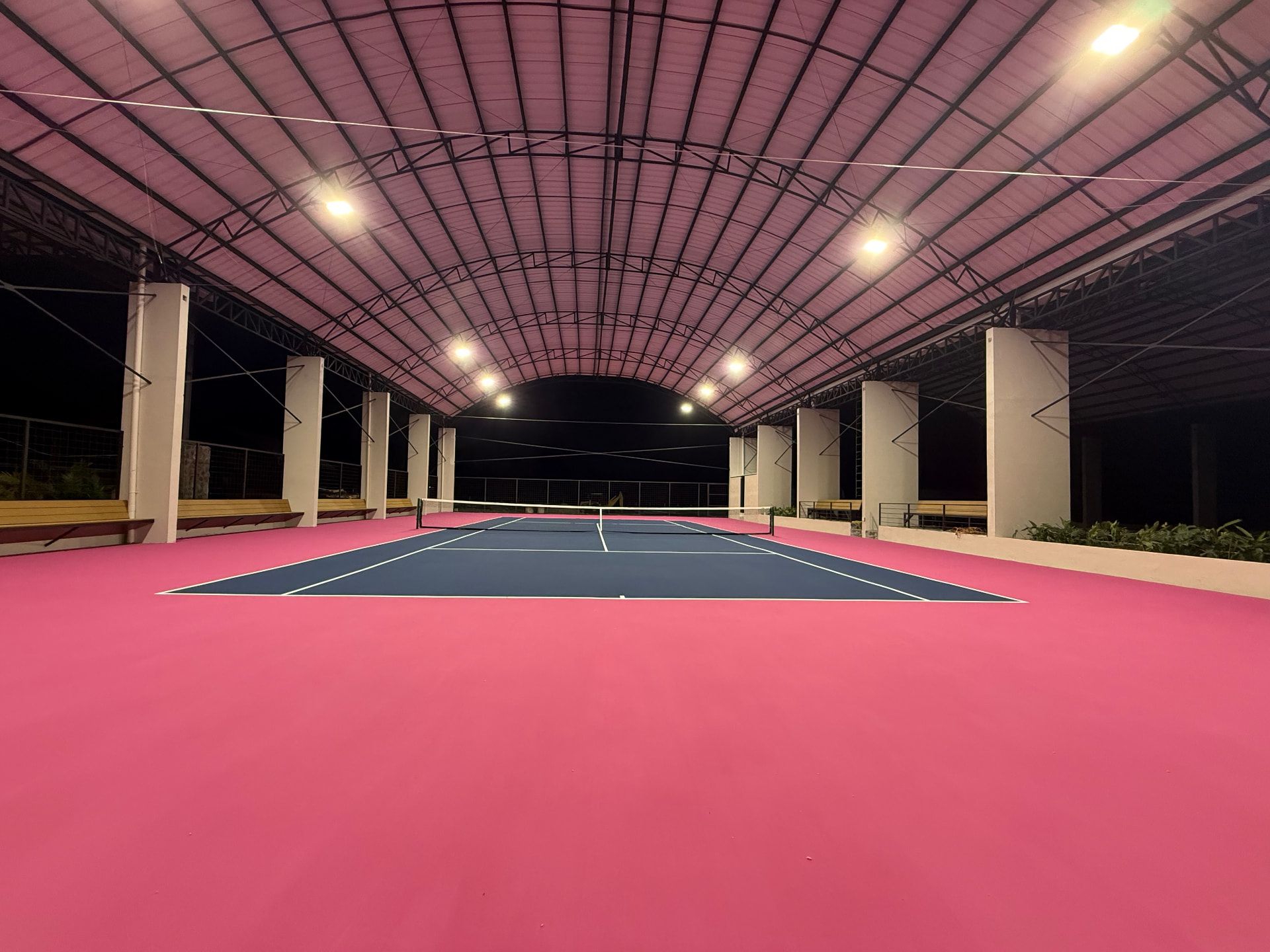 Covered tennis court at Finca Escondida lit for night play
